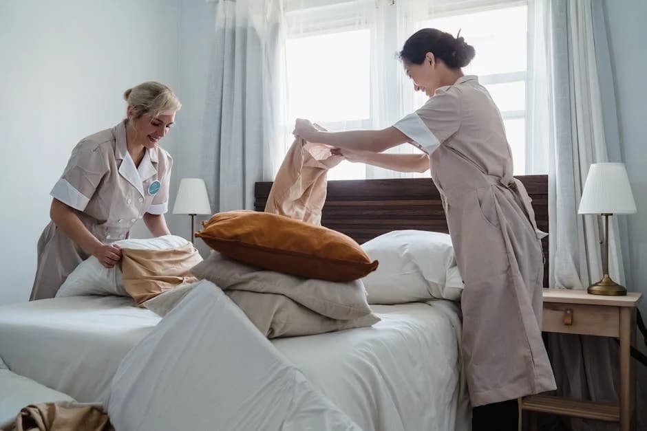 Professional hotel cleaning team maintaining guest room and lobby cleanliness
