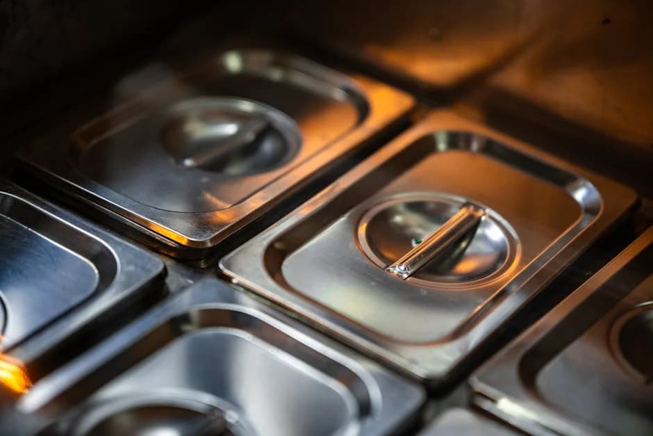 Professional team cleaning a commercial kitchen hood and cooking equipment