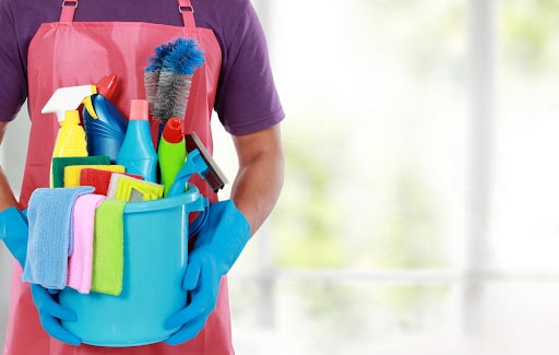 Portrait of man with cleaning equipment ready to clean house